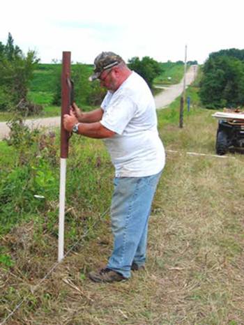 Driving PasturePro posts with t-post driver, building fence